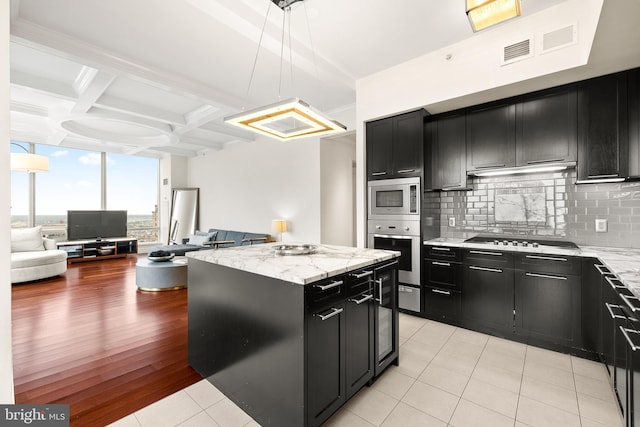 1414 S Penn Sq Unit 34B, Philadelphia, PA 19102 - kitchen with coffered ceiling, open floor plan, appliances with stainless steel finishes, and dark cabinetry