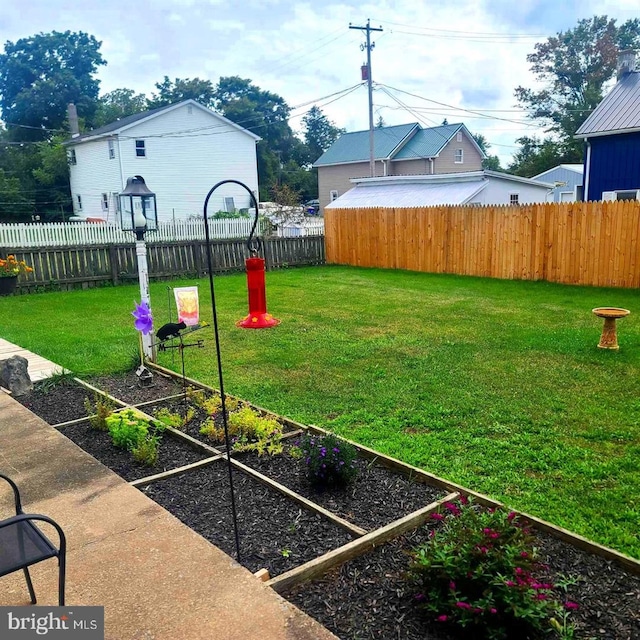 view of yard with a fenced backyard and a vegetable garden