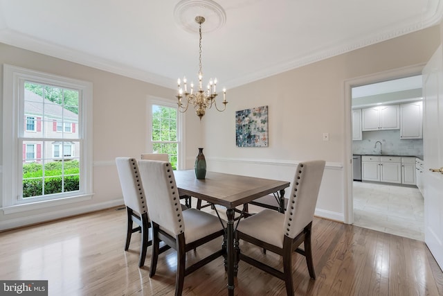 12600 Tolman Rd, Fairfax, VA 22033 - dining room with a chandelier, plenty of natural light, light wood-style flooring, and crown molding