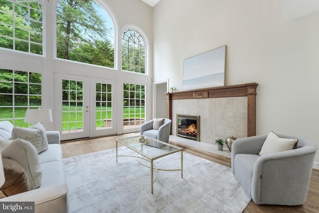 12600 Tolman Rd, Fairfax, VA 22033 - living area featuring a towering ceiling, a fireplace, wood finished floors, and french doors