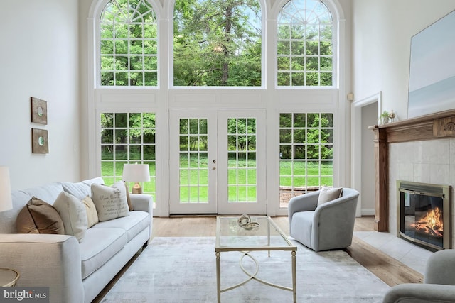 12600 Tolman Rd, Fairfax, VA 22033 - living area featuring a high ceiling, a tiled fireplace, and french doors
