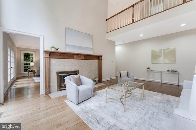 12600 Tolman Rd, Fairfax, VA 22033 - living room with wood finished floors, a fireplace, a towering ceiling, baseboards, and recessed lighting