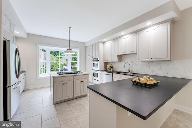 12600 Tolman Rd, Fairfax, VA 22033 - kitchen featuring stainless steel appliances, a sink, dark countertops, a peninsula, and decorative backsplash