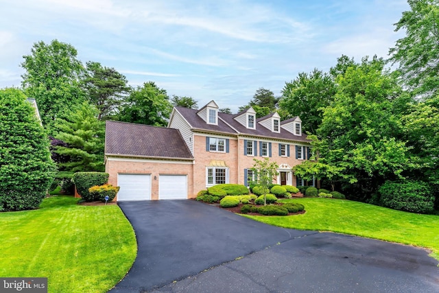 12600 Tolman Rd, Fairfax, VA 22033 - colonial home with brick siding, an attached garage, driveway, and a front yard