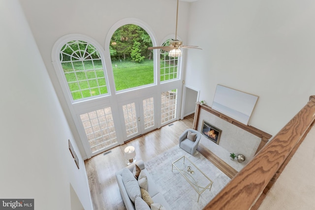 12600 Tolman Rd, Fairfax, VA 22033 - living area featuring a high ceiling, a fireplace, ceiling fan, french doors, and wood finished floors