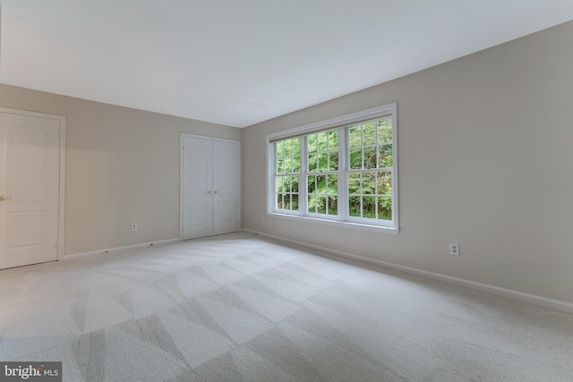 12600 Tolman Rd, Fairfax, VA 22033 - unfurnished bedroom with baseboards, light carpet, and a closet