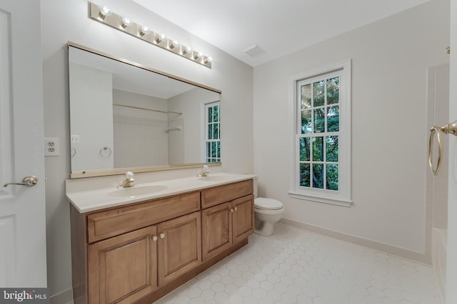 12600 Tolman Rd, Fairfax, VA 22033 - bathroom with double vanity, toilet, shower / tub combination, tile patterned floors, and baseboards