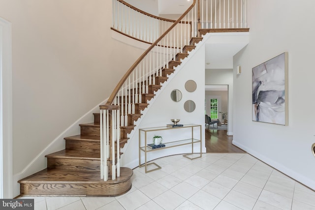 12600 Tolman Rd, Fairfax, VA 22033 - staircase featuring a high ceiling, baseboards, and tile patterned floors