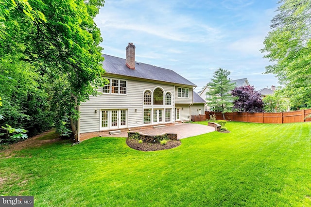 12600 Tolman Rd, Fairfax, VA 22033 - rear view of house featuring french doors, a patio area, and a chimney