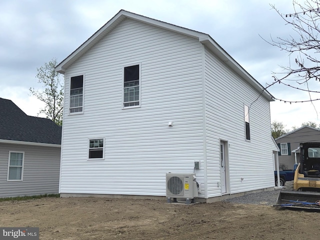 rear view of house featuring ac unit