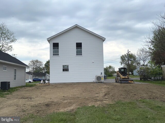 rear view of house with ac unit and central air condition unit