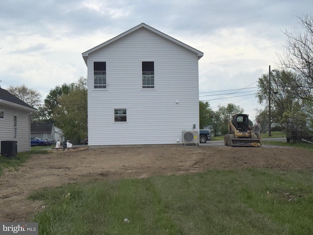 view of side of home with central air condition unit