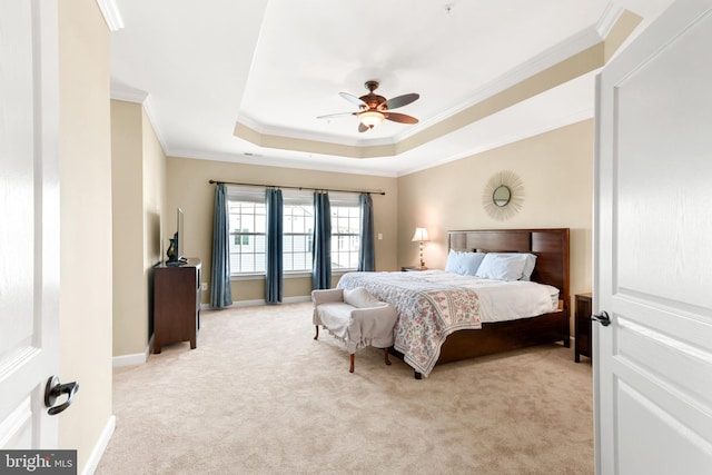 bedroom with crown molding, a raised ceiling, light carpet, and a ceiling fan