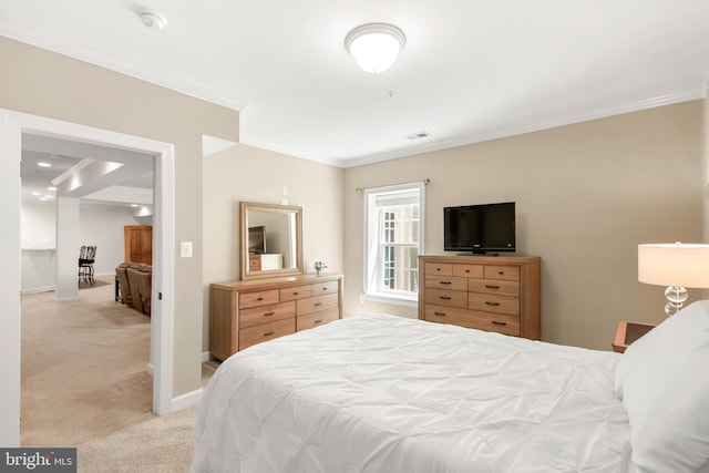 bedroom with crown molding, baseboards, visible vents, and light carpet