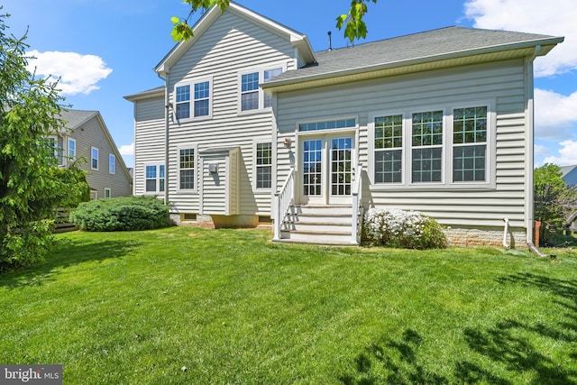 rear view of property with a lawn, crawl space, and entry steps