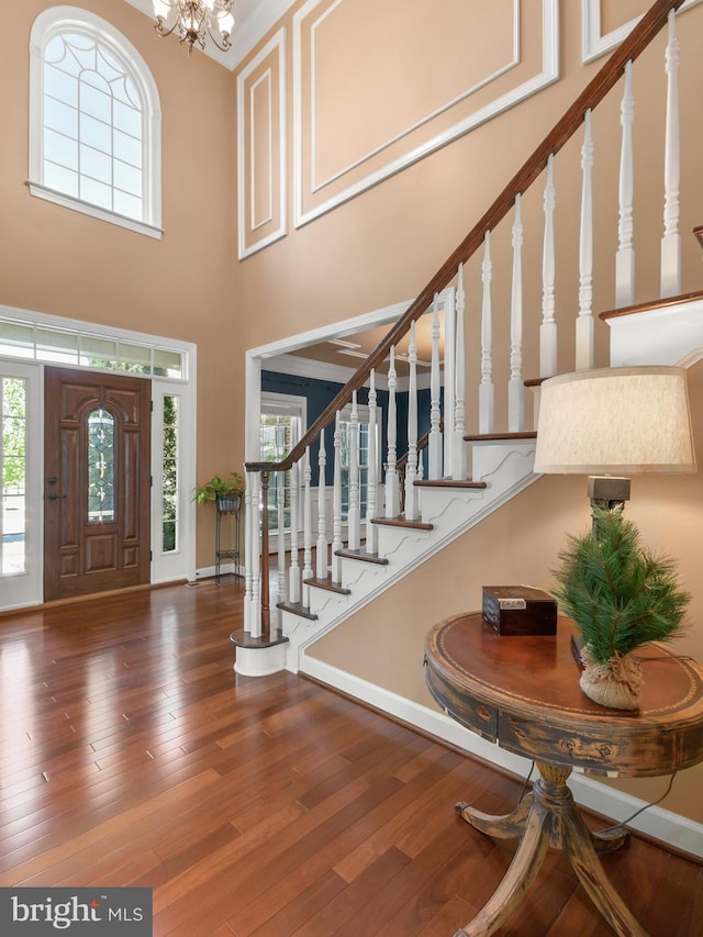 foyer entrance with a high ceiling, stairs, and a wealth of natural light