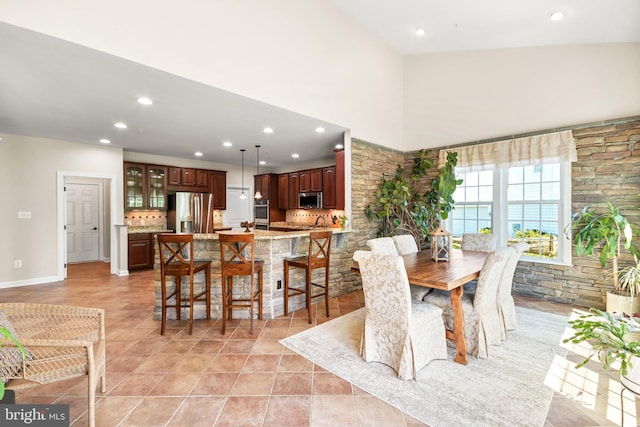 dining area featuring recessed lighting, a high ceiling, and light tile patterned floors