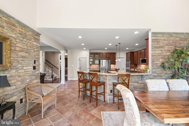 dining area with stairs, baseboards, ornate columns, recessed lighting, and light tile patterned floors