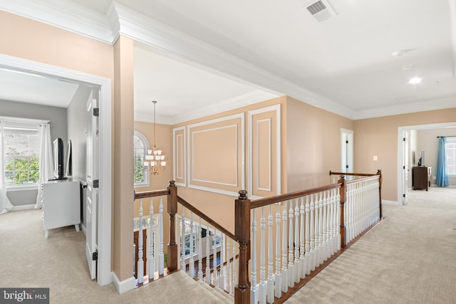 corridor featuring crown molding, visible vents, an upstairs landing, and carpet