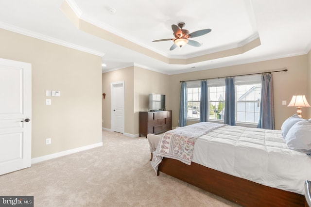 bedroom featuring ceiling fan, a raised ceiling, baseboards, ornamental molding, and light carpet