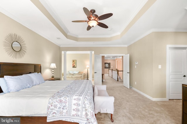 bedroom with ceiling fan, crown molding, a raised ceiling, baseboards, and light carpet