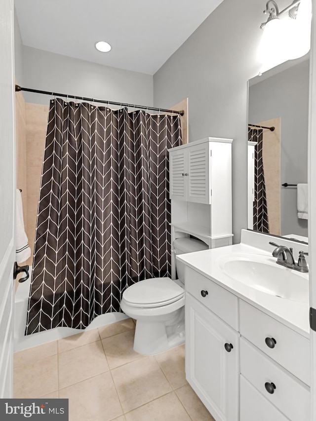 bathroom with a shower with curtain, tile patterned flooring, vanity, and toilet