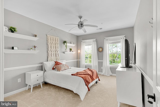 carpeted bedroom featuring visible vents, a ceiling fan, and baseboards