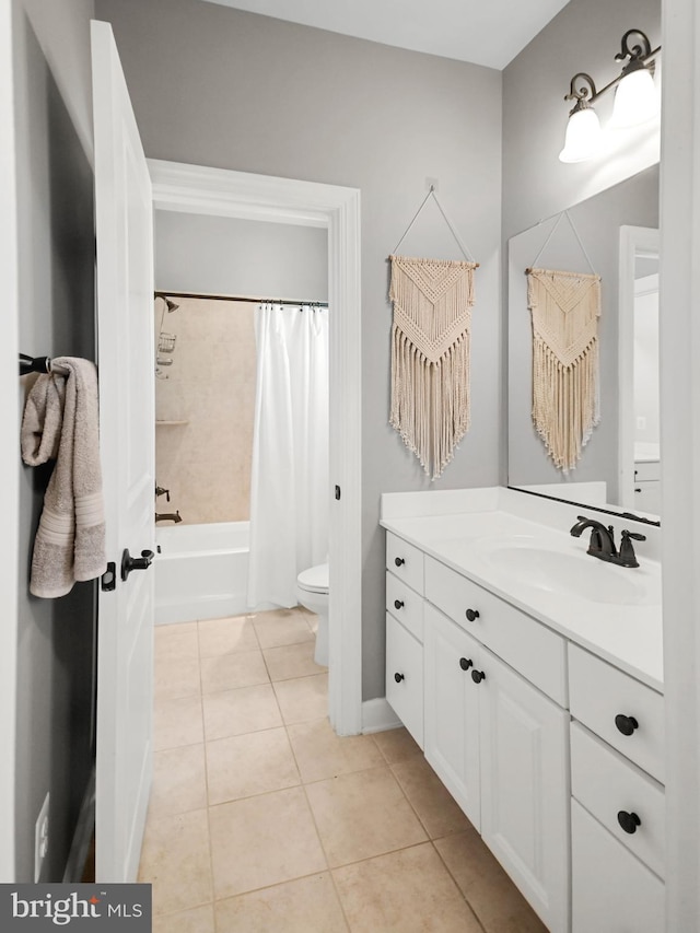 full bath featuring tile patterned flooring, vanity, toilet, shower / bath combination with curtain, and baseboards
