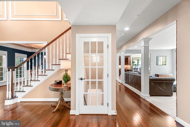 foyer entrance with ornate columns, recessed lighting, wood-type flooring, and stairs