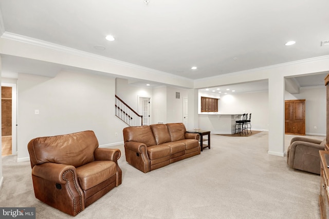 living area with crown molding, stairs, and light colored carpet
