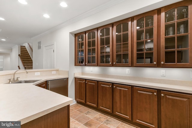 kitchen with crown molding, a sink, recessed lighting, and light countertops