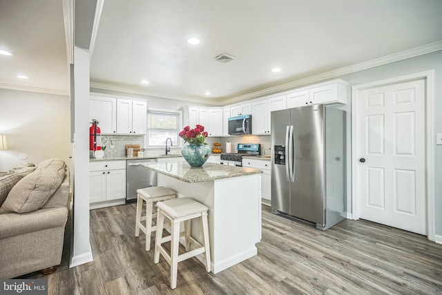 32 Meadowlark Ln, Willingboro, NJ 08046 - kitchen with a sink, ornamental molding, stainless steel appliances, and light wood-type flooring