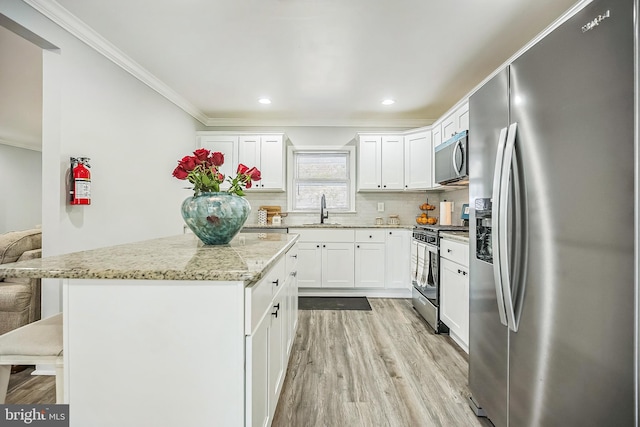 32 Meadowlark Ln, Willingboro, NJ 08046 - kitchen with crown molding, a sink, light wood-style floors, a center island, and stainless steel appliances