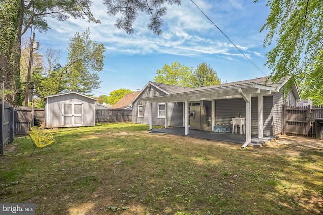 32 Meadowlark Ln, Willingboro, NJ 08046 - back of house with a lawn, a patio area, an outdoor structure, a fenced backyard, and a storage unit