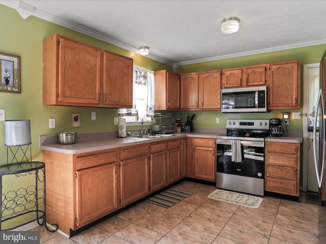 kitchen featuring light countertops, ornamental molding, and stainless steel appliances