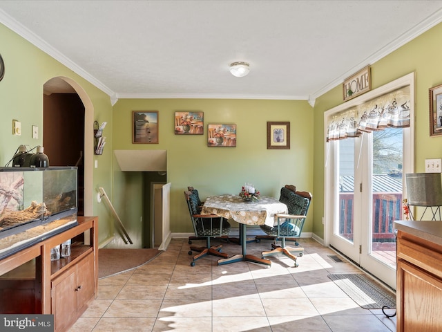 dining room with arched walkways, ornamental molding, light tile patterned flooring, and visible vents