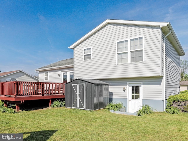 rear view of house with an outbuilding, a yard, a wooden deck, and a storage shed