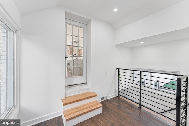 interior space with recessed lighting, wood finished floors, vaulted ceiling, baseboards, and visible vents