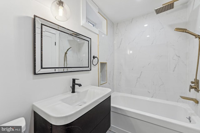 bathroom featuring visible vents, toilet, shower / bathtub combination, and vanity