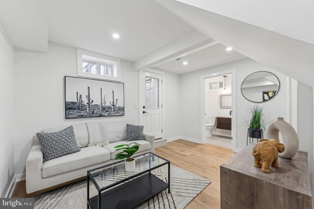 living area featuring baseboards, recessed lighting, and light wood-style floors