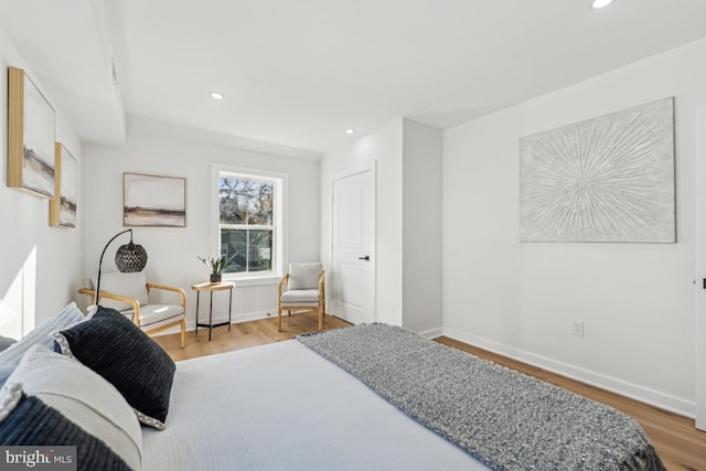 bedroom featuring recessed lighting, wood finished floors, and baseboards