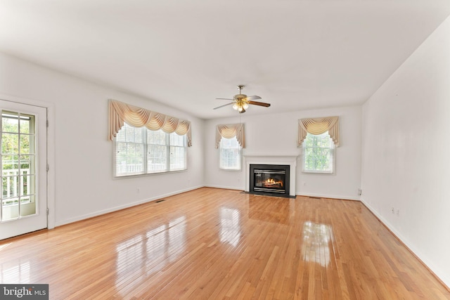 42935 Palliser Ct, Leesburg, VA 20176 - unfurnished living room with a fireplace with flush hearth, ceiling fan, light wood-type flooring, and baseboards