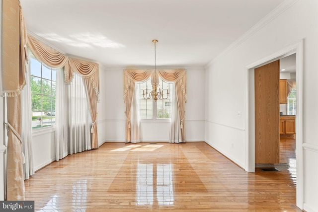 42935 Palliser Ct, Leesburg, VA 20176 - unfurnished dining area with a chandelier, crown molding, light wood-style flooring, and baseboards