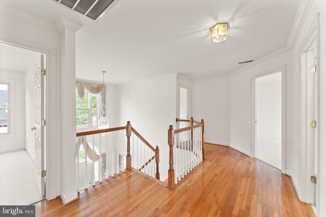 42935 Palliser Ct, Leesburg, VA 20176 - hall featuring crown molding, light wood-style flooring, an upstairs landing, visible vents, and baseboards