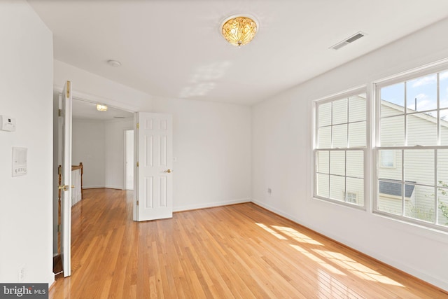 42935 Palliser Ct, Leesburg, VA 20176 - unfurnished room with visible vents, a healthy amount of sunlight, and light wood-style floors