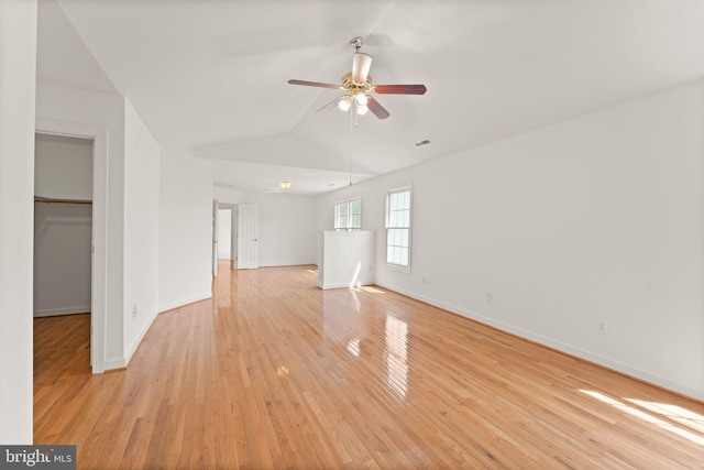 42935 Palliser Ct, Leesburg, VA 20176 - unfurnished living room with light wood-style floors, ceiling fan, visible vents, vaulted ceiling, and baseboards