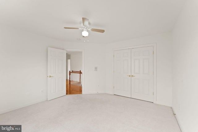 42935 Palliser Ct, Leesburg, VA 20176 - unfurnished bedroom featuring a closet, baseboards, a ceiling fan, and light carpet