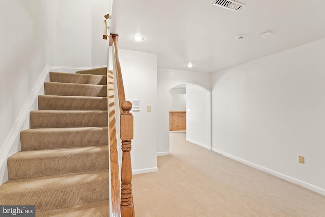 42935 Palliser Ct, Leesburg, VA 20176 - stairway featuring recessed lighting, arched walkways, carpet floors, baseboards, and visible vents