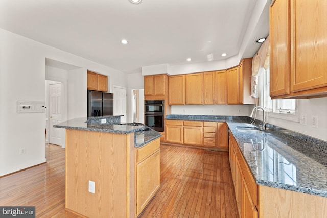 42935 Palliser Ct, Leesburg, VA 20176 - kitchen with dark stone countertops, light wood finished floors, a sink, and stainless steel refrigerator with ice dispenser