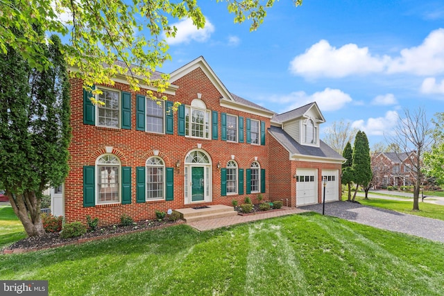 42935 Palliser Ct, Leesburg, VA 20176 - view of front of home featuring a front lawn, driveway, an attached garage, and brick siding